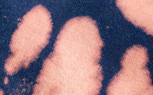Bleach stains on navy cotton fabric
