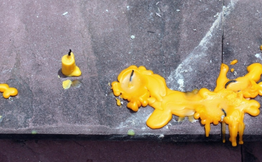 Yellow melted candel on table